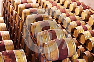 Waiting until the time is right. Red wine barrels stored in wine cellar.