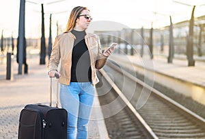 Waiting for train. Woman buying electronic ticket.