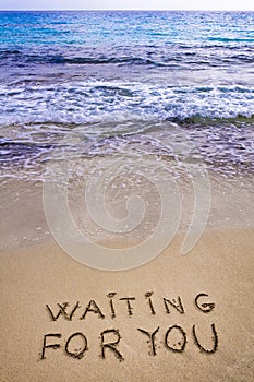 Waiting for you written in a sandy tropical beach