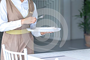 Waitress against empty tableware, table setting. close up