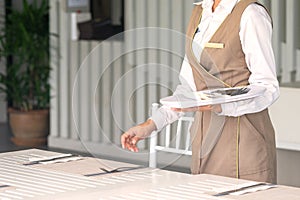 Waitress against empty tableware, table setting. close up