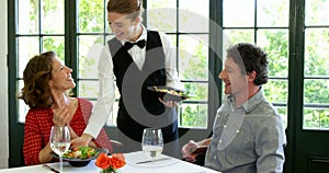 Waitress bringing a couples order