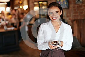 Waitress In Cafe. Woman With Chocolate Candies In Confectionery