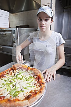 Waitress with cap serving a slice of all dressed p