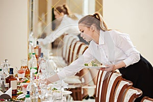 Waitress at catering work in a restaurant photo