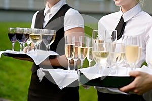 Waitress with dish of champagne glasses