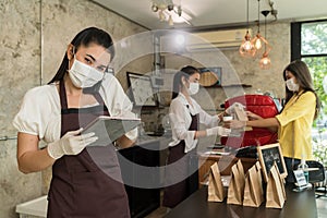 Waitress with face mask take order for curbside pick up and takeout