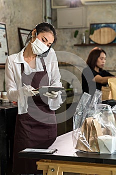 Waitress with face mask take order for curbside pick up and takeout