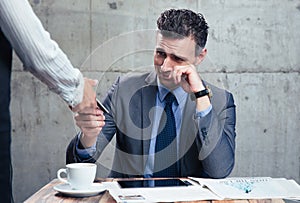 Waitress giving bank card to upset man