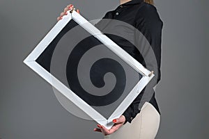 Waitress holding tilted chalkboard