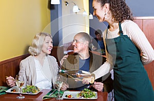 Waitress with mature guests .