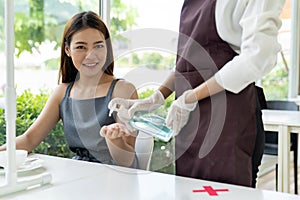 Waitress push hand sanitizer for customer