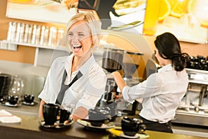 Waitress serving coffee cups making espresso woman