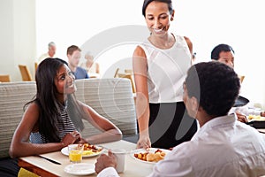 Waitress Serving Couple Breakfast In Hotel Restaurant