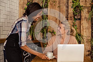 Waitress serving a cup of coffee to customer