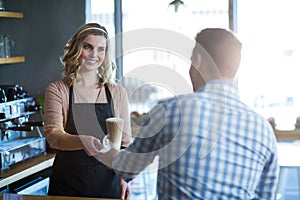 Waitress serving a cup of cold coffee to customer