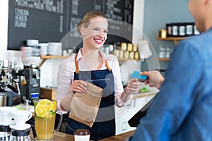 Waitress serving customer at the coffee shop