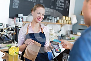 Waitress serving customer at the coffee shop