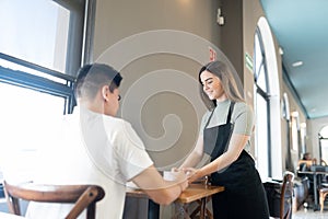 Waitress serving food to customer