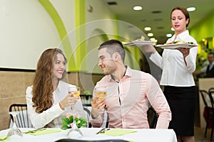 Waitress serving food to visitors