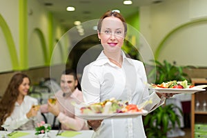 Waitress serving food to visitors