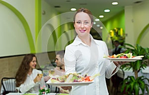 Waitress serving food to visitors