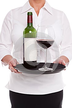 Waitress serving red wine with glass and bottle on a tray.