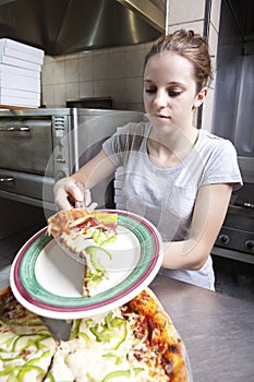 Waitress serving a slice of all dressed pizza