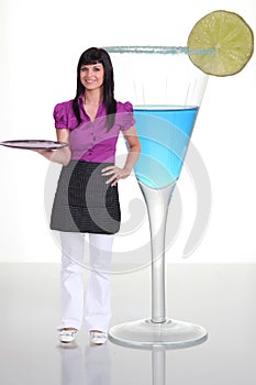 Waitress standing next to cocktail