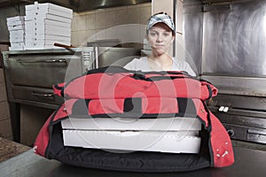 Waitress with take out pizza in a thermal bag