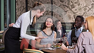 Waitress talking with satisfied guests