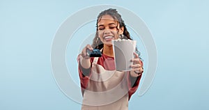 Waitress woman, machine and payment in studio, popcorn and smile on face with service by blue background. Girl, cinema