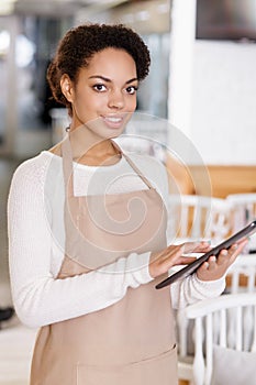 Waitress working with portable tablet