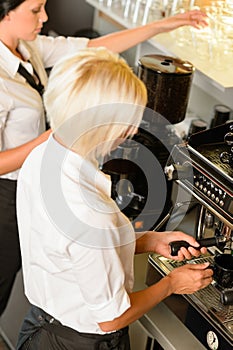 Waitresses at work make coffee machine cafe