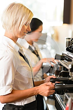 Waitresses at work make coffee machine cafe