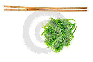 Wakame seaweed and chopsticks isolated on white background