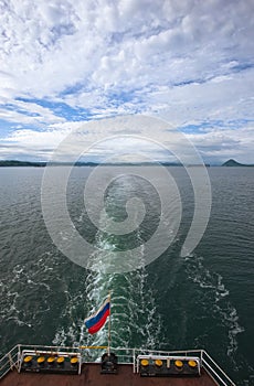 The wake astern of the ship under the Russian flag.