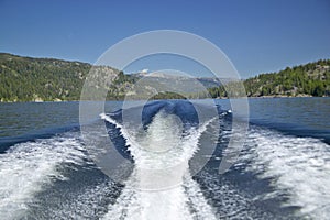 Wake from boat on Lake McCall, Idaho and Pine Trees in summer