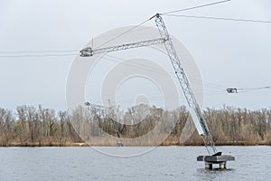 Wake cable park for wakeboarding on river. Pulley system reverse equipment wakeboard in water. Traction water snowboard halyard photo