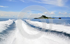 Wake caused by cruise ship or trace tails of speed boat on water