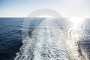 Wake of a cruise ship during clear blue day