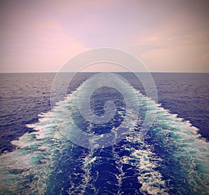 Wake of the cruise ship on the water of the Sea with old effect