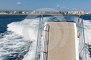 Wake and Gangway of ferry leaving harbor of Milazzo, Italy