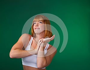 Wake up beauty, its time to beast. an attractive young sportswoman standing alone and posing against a green background