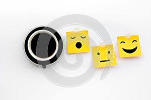 Wake up concepts with coffee drink and emoticon face on notepaper on white