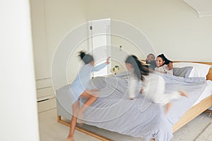 Wake up, happy family and playing in bed in the morning, bond and having fun in their home together. Love, bedroom and