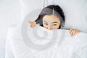 Wake up. Lonely Beautiful young asian woman waking up after good night sleep, in the morning in bed