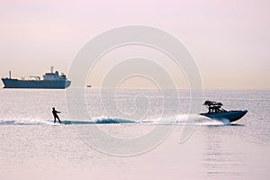 Wakeboading at front of tanker at midday