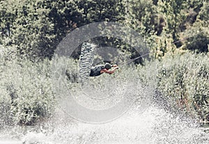 Wakeboarder jump over the lake. Tonned photo