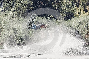 Wakeboarder jump over the lake. Tonned photo